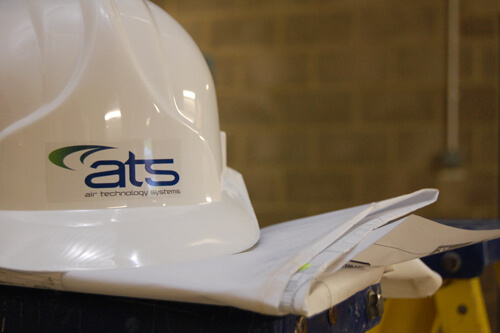 Service-Maintenance ATS hardhat next to site documentation