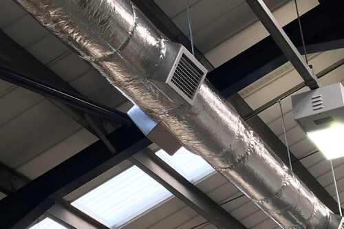 Warehouse ductwork showing extractor fan